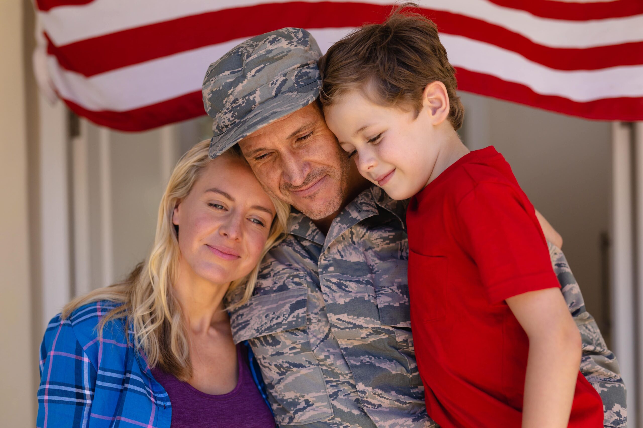 Government contract moving services - Military family at entrance of new home with veteran mover