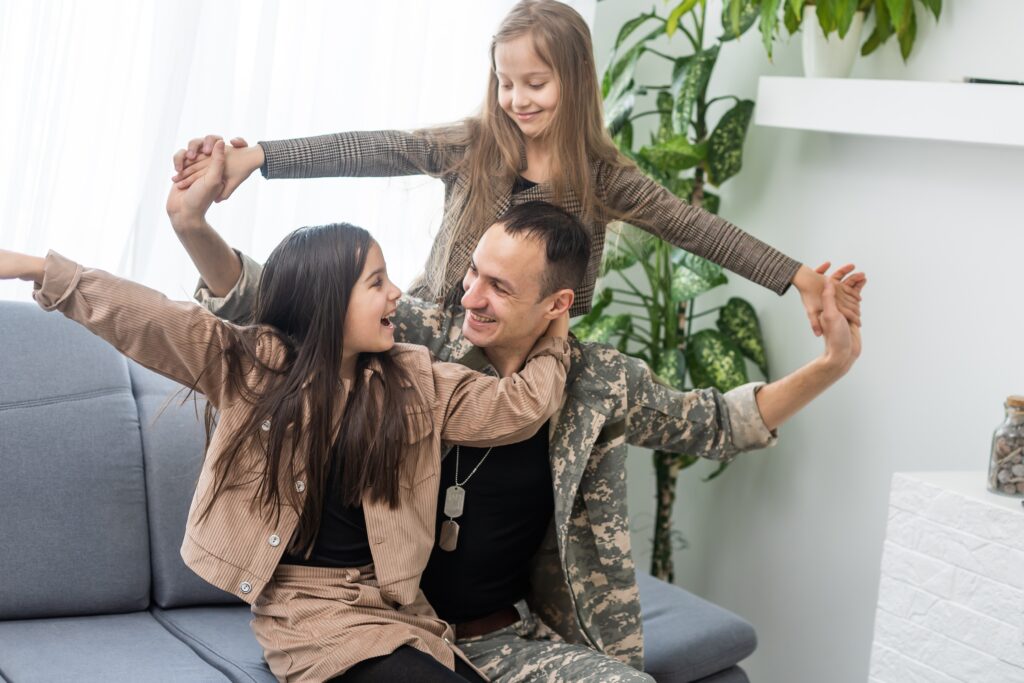 beautiful little daughters and military father at home